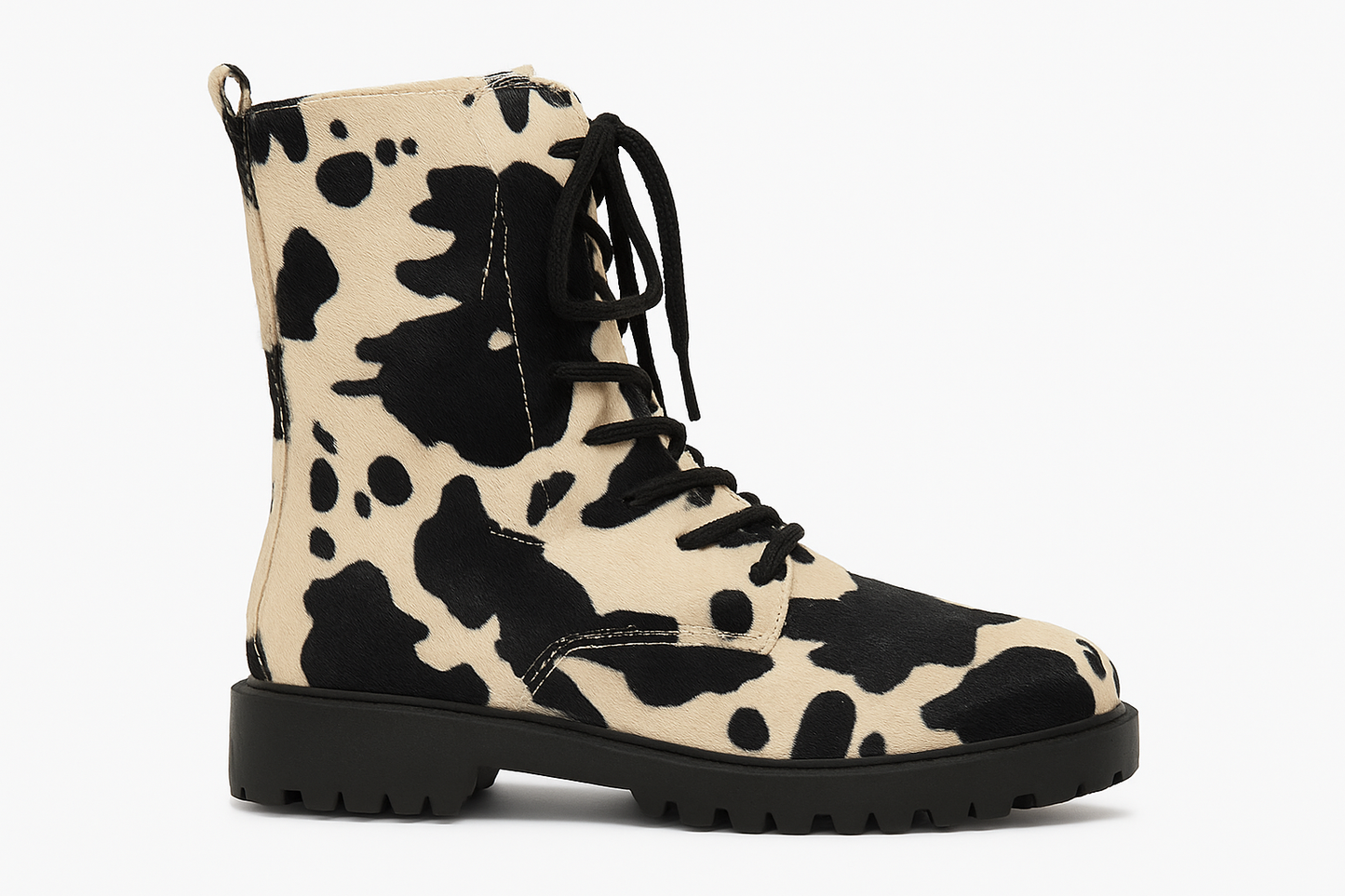 Cow print boot with black laces on a white background