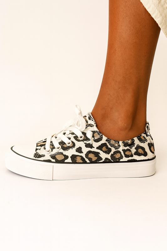 Leopard print sneaker worn by a person on a white background