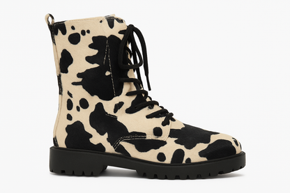 Cow print boot with black laces on a white background